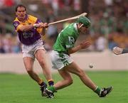 29 July 2001; Adrian Fenlon of Wexford in action against Mike O'Brien of Limerick during the Guinness All-Ireland Senior Hurling Championship Quarter-Final match between Wexford and Limerick at Croke Park in Dublin. Photo by Damien Eagers/Sportsfile