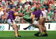29 July 2001; Sean O'Connor of Limerick is tackled by Declan Ruth, right, and Liam Dunne of Wexford during the Guinness All-Ireland Senior Hurling Championship Quarter-Final match between Wexford and Limerick at Croke Park in Dublin. Photo by Damien Eagers/Sportsfile