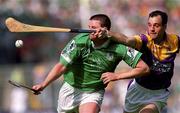29 July 2001; Brian Begley of Limerick is tackled by Darragh Ryan of Wexford during the Guinness All-Ireland Senior Hurling Championship Quarter-Final match between Wexford and Limerick at Croke Park in Dublin. Photo by Damien Eagers/Sportsfile