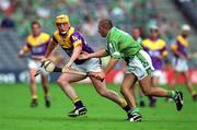 29 July 2001; Garry Laffan of Wexford in action against Clement Smith of Limerick during the Guinness All-Ireland Senior Hurling Championship Quarter-Final match between Wexford and Limerick at Croke Park in Dublin. Photo by Damien Eagers/Sportsfile