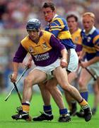 17 August 1997; Liam Dunne of Wexford in action against Liam McGrath of Tipperary during the Guinness All-Ireland Senior Hurling Championship Semi-Final match between Tipperary and Wexford at Croke Park in Dublin. Photo by David Maher/Sportsfile