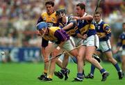 17 August 1997; Eugene Furlong of Wexford in action against Liam McGrath of Tipperary during the Guinness All-Ireland Senior Hurling Championship Semi-Final match between Tipperary and Wexford at Croke Park in Dublin. Photo by David Maher/Sportsfile