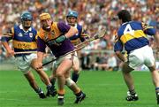 17 August 1997; Garry Laffan of Wexford in action against Michael Ryan, right, Colm Bonnar, left, and Noel Sheehy of Tipperary during the Guinness All-Ireland Senior Hurling Championship Semi-Final match between Tipperary and Wexford at Croke Park in Dublin. Photo by David Maher/Sportsfile
