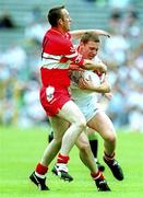5 August 2001; Cormac McAnallen of Tyrone in action against Dermot Dougan of Derry during the Bank of Ireland All-Ireland Senior Football Championship Quarter-Final match between Derry v Tyrone at St. Tiernach's Park in Clones, Monaghan. Photo by David Maher/Sportsfile