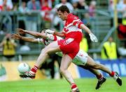 5 August 2001; Anthony Tohill of Derry of in action against Declan McCrossan of Tyrone during the Bank of Ireland All-Ireland Senior Football Championship Quarter-Final match between Derry v Tyrone at St. Tiernach's Park in Clones, Monaghan. Photo by David Maher/Sportsfile