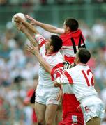 5 August 2001; Derry players, Enda Muldoon, 14, and Patrick Bradley in action against Colin Holmes and Pascal Canavan, 12, of Tyrone during the Bank of Ireland All-Ireland Senior Football Championship Quarter-Final match between Derry v Tyrone at St. Tiernach's Park in Clones, Monaghan. Photo by David Maher/Sportsfile