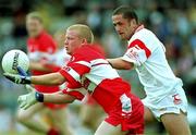 5 August 2001; Gareth Doherty of Derry in action against Stepehen O'Neill of Tyrone during the Bank of Ireland All-Ireland Senior Football Championship Quarter-Final match between Derry v Tyrone at St. Tiernach's Park in Clones, Monaghan. Photo by David Maher/Sportsfile