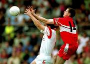 5 August 2001; Enda Muldoon of Derry in action against Colin Holmes of Tyrone during the Bank of Ireland All-Ireland Senior Football Championship Quarter-Final match between Derry v Tyrone at St. Tiernach's Park in Clones, Monaghan. Photo by David Maher/Sportsfile