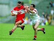 5 August 2001; Kieran McNally of Derry in action against Brian Dooher of Tyrone during the Bank of Ireland All-Ireland Senior Football Championship Quarter-Final match between Derry v Tyrone at St. Tiernach's Park in Clones, Monaghan. Photo by David Maher/Sportsfile