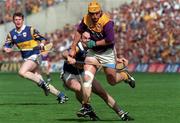 17 August 1997; Garry Laffan of Wexford in action against Michael Ryanduring of Tipperary during the Guinness All-Ireland Senior Hurling Championship Semi-Final match between Tipperary and Wexford at Croke Park in Dublin. Photo by David Maher/Sportsfile