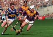17 August 1997; Tom Dempsey of Wexford in action against Conor Gleeson of Tipperary during the Guinness All-Ireland Senior Hurling Championship Semi-Final match between Tipperary and Wexford at Croke Park in Dublin. Photo by David Maher/Sportsfile