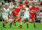 5 August 2001; Patrick Bradley of Derry in action against Colin Holmes of Tyrone during the Bank of Ireland All-Ireland Senior Football Championship Quarter-Final match between Derry v Tyrone at St. Tiernach's Park in Clones, Monaghan. Photo by David Maher/Sportsfile