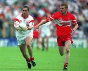 5 August 2001; Stephen O'Neill of Tyrone in action against Fergal Doherty of Derry during the Bank of Ireland All-Ireland Senior Football Championship Quarter-Final match between Derry v Tyrone at St. Tiernach's Park in Clones, Monaghan. Photo by David Maher/Sportsfile