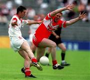 5 August 2001; Ciaran Gourley of Tyrone in action against Dermot Heaney of Derry during the Bank of Ireland All-Ireland Senior Football Championship Quarter-Final match between Derry v Tyrone at St. Tiernach's Park in Clones, Monaghan. Photo by David Maher/Sportsfile