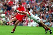 5 August 2001; Gavin Diamond of Derry in action against Pascal Canavan of Tyrone during the Bank of Ireland All-Ireland Senior Football Championship Quarter-Final match between Derry v Tyrone at St. Tiernach's Park in Clones, Monaghan. Photo by David Maher/Sportsfile