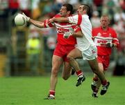 5 August 2001; Anthony Tohill of Derry in action against Declan McCrossan of Tyrone during the Bank of Ireland All-Ireland Senior Football Championship Quarter-Final match between Derry v Tyrone at St. Tiernach's Park in Clones, Monaghan. Photo by David Maher/Sportsfile