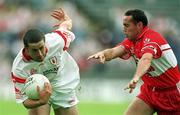 5 August 2001; Stephen O'Neill of Tyrone in action against Gary Coleman of Derry during the Bank of Ireland All-Ireland Senior Football Championship Quarter-Final match between Derry v Tyrone at St. Tiernach's Park in Clones, Monaghan. Photo by David Maher/Sportsfile