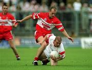 5 August 2001; Sean Teague of Tyrone in action against Kevin McCloy of Derry during the Bank of Ireland All-Ireland Senior Football Championship Quarter-Final match between Derry v Tyrone at St. Tiernach's Park in Clones, Monaghan. Photo by David Maher/Sportsfile