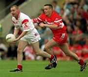 5 August 2001; Sean Teague of Tyrone in action against Patrick Bradley of Derry during the Bank of Ireland All-Ireland Senior Football Championship Quarter-Final match between Derry v Tyrone at St. Tiernach's Park in Clones, Monaghan. Photo by David Maher/Sportsfile