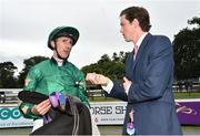 14 July 2016; Jockey George Baker in conversation  with Tom Charlton, representing his father trainer Roger Charlton, after winning the ICON Meld Stakes on Decorated Knight during the Bulmers Evening Meeting at Leopardstown in Dublin. Photo by Cody Glenn/Sportsfile
