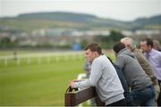 14 July 2016; Grooms watch the Irish Stallion Farms European Breeders Fund Maiden during the Bulmers Evening Meeting at Leopardstown in Dublin. Photo by Cody Glenn/Sportsfile