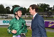 14 July 2016; Jockey George Baker in conversation  with Tom Charlton, representing his father - trainer Roger Charlton, after winning the ICON Meld Stakes on Decorated Knight during the Bulmers Evening Meeting at Leopardstown in Dublin. Photo by Cody Glenn/Sportsfile