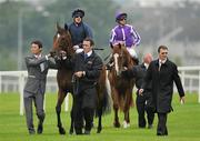 4 September 2010; Trainer Aidan O'Brien, with 2 of his horses, Rip Van Winkle, left, with Johnny Murtagh up, and eventual winner Cape Blanco, with Seamus Heffernan up, before the Tattersalls Millions Irish Champion Stakes. Leopardstown Racecourse, Dublin. Picture credit: Brendan Moran / SPORTSFILE