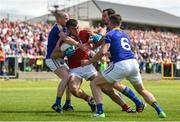 16 July 2016; Peter Kelleher of Cork is tackled by Dermot Brady, left, Barry Gilleran, centre, and Michael Quinn of Longford during the GAA Football All-Ireland Senior Championship Round 3B match between Longford and Cork at Glennon Brothers Pearse Park in Longford. Photo by Ramsey Cardy/Sportsfile