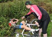 16 July 2016; Leader of the King of the Mountains classification Eoghan McLoughlin of Connaught Team is offered a helping hand after collapsing at the finish of Stage 5 of the 2016 Scott Bicycles Junior Tour of Ireland, Gallows Hill, Co. Clare. Picture credit: Stephen McMahon/SPORTSFILE