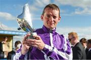16 July 2016; Jockey Seamie Heffernan celebrates  with the trophy after winning the Darley Irish Oaks, aboard Seventh Heaven, at the Curragh Racecourse in the Curragh, Co Kildare. Photo by Sportsfile