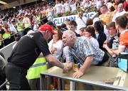 17 July 2016; Tyrone manager Mickey Harte greeting a Tyrone supporter after the Ulster GAA Football Senior Championship Final match between Donegal and Tyrone at St Tiernach's Park in Clones, Co Monaghan. Photo by Philip Fitzpatrick/Sportsfile