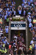 17 July 2016; Brian Fenton of Dublin lifts the Delaney cup, while the Westmeath team leave the field after the Leinster GAA Football Senior Championship Final match between Dublin and Westmeath at Croke Park in Dubin. Photo by Daire Brennan/Sportsfile
