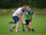 20 July 2016; Peter Dooley of Leinster is tackled by Tom Hughes, aged 10, from Tullow, Co. Carlow, during the Bank of Ireland Leinster Rugby Summer Camp at Tullow RFC in Tullow, Co Carlow. Photo by Daire Brennan/Sportsfile