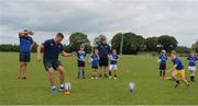 21 July 2016; Josh van der Flier of Leinster practices kicking with Ross Adams, aged 9, from Portlaoise, Co. Laois, during the Bank of Ireland Leinster Rugby Summer Camp at Portlaoise RFC in Portlaoise, Co. Laois. Photo by Daire Brennan/Sportsfile
