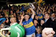 11 September 2010; The Tipperary captain Padraic Maher, with Uachtarán Chumann Lúthchleas Gael Criostóir Ó Cuana, left, and John Mullins, CEO, Bord Gais, right, lifts the trophy.  Bord Gais Energy GAA Hurling Under 21 All-Ireland Championship Final, Tipperary v Galway, Semple Stadium, Thurles, Co. Tipperary. Picture credit: Ray McManus / SPORTSFILE