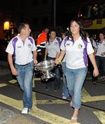 13 September 2010; Wexford manager JJ Doyle and captain Una Lacey carry the O'Duffy Cup from the open top bus at their homecoming as Gala All-Ireland Senior Camogie Champions, Wexford Quay, Wexford. Picture credit: Barry Cregg / SPORTSFILE