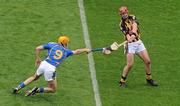 5 September 2010; Eoin Larkin, Kilkenny, is hooked by Shane McGrath, Tipperary. GAA Hurling All-Ireland Senior Championship Final, Kilkenny v Tipperary, Croke Park, Dublin. Picture credit: Brendan Moran / SPORTSFILE