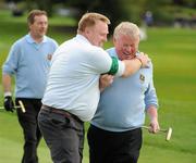 17 September 2010; Caddie Dominic Cribben congratulates  his Curragh Golf Club, Co. Killdare, team-mate Eddie Trant, who had just sunk a 12 foot putt on his last hole, the 16th, to win the Bulmers Pierce Purcell Shield Final. Bulmers Cups and Shields Finals 2010, Castlebar Golf Club, Co. Mayo. Picture credit: Ray McManus / SPORTSFILE