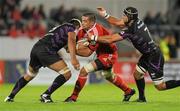 18 September 2010; Alan Quinlan, Munster, is tackled by Jerry Collins, left, and Marty Holah, Ospreys. Celtic League, Munster v Ospreys, Thomond Park, Limerick. Picture credit: Diarmuid Greene / SPORTSFILE