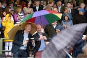 26 July 2016; Brian Osborne, left, from Galway City, and Jeremy O'Connor, from Douglas, Co Cork, snap a selfie under the shelter of their umbrellas at the Galway Races in Ballybrit, Co Galway. Photo by Cody Glenn/Sportsfile