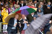 26 July 2016; Brian Osborne, left, from Galway City, and Jeremy O'Connor, from Douglas, Co Cork, snap a selfie under the shelter of their umbrellas at the Galway Races in Ballybrit, Co Galway. Photo by Cody Glenn/Sportsfile