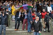 26 July 2016; Brian Osborne, centre, from Galway City, and Jeremy O'Connor, from Douglas, Co Cork, snap a selfie under the shelter of their umbrellas at the Galway Races in Ballybrit, Co Galway. Photo by Cody Glenn/Sportsfile
