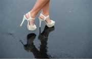 26 July 2016; A racegoer strides through a puddle as she departs the races at the Galway Races in Ballybrit, Co Galway. Photo by Cody Glenn/Sportsfile