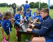 27 July 2016; Alex O'Shea, aged 7, from Clondalkin, Co. Dublin, has her boot signed by Garry Ringrose of Leinster during the Bank of Ireland Leinster Rugby Summer Camp at Clondalkin RFC in Kingswood Cross, Dublin. Photo by Daire Brennan/Sportsfile