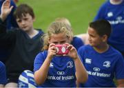 27 July 2016; Adara Carthy, aged 9, from Celbridge, Co. Kildare, takes a photo during the Bank of Ireland Leinster Rugby Summer Camp at Clondalkin RFC in Kingswood Cross, Dublin. Photo by Daire Brennan/Sportsfile