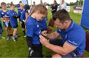 27 July 2016; Leinster's Cian Healy signs an autograph for Holly Bale, age 10, from Kildare Town, during the Bank of Ireland Leinster Rugby Summer Camp at Cill Dara RFC in Dunmurray West, Kildare. Photo by Piaras Ó Mídheach/Sportsfile