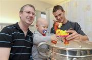 20 September 2010; Cork player Eoin Cadogan with Ciaran O'Sullivan, aged 3, and his father Paul, from Beara, Co. Cork, during a team visit to Our Lady's Hospital for Sick Children, Crumlin, Dublin. Picture credit: Barry Cregg / SPORTSFILE