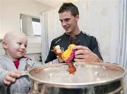 20 September 2010; Cork player Eoin Cadogan with Ciaran O'Sullivan, aged 3, from Beara, Co. Cork, during a team visit to Our Lady's Hospital for Sick Children, Crumlin, Dublin. Picture credit: Barry Cregg / SPORTSFILE