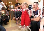 20 September 2010; Sarah Maher, from Dublin, stands in  the Sam Maguire Cup while meeting Noel O'Leary and the Cork players during a team visit to Our Lady's Hospital for Sick Children, Crumlin, Dublin. Picture credit: Barry Cregg / SPORTSFILE