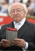 27 July 2016; The President of Ireland Michael D. Higgins studies the form at the Galway Races in Ballybrit, Co Galway. Photo by Cody Glenn/Sportsfile